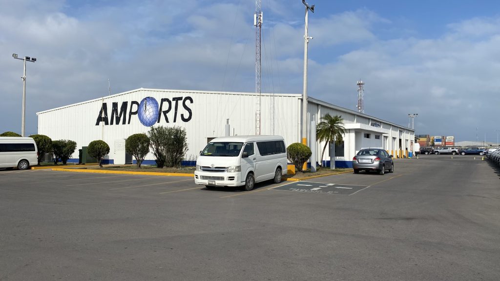 A white building featuring Amports' logo on its exterior