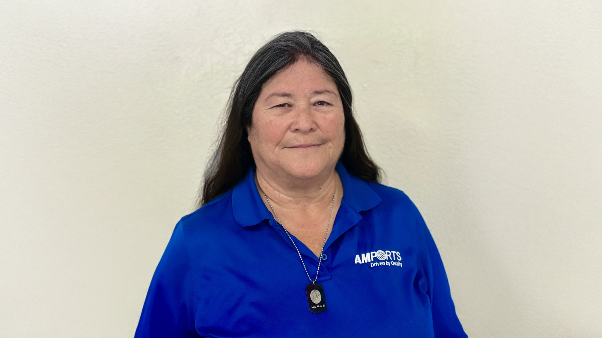 A portrait of Terry Smith wearing Amport's blue polo uniform.