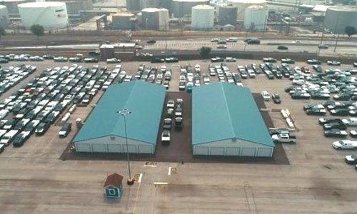 An aerial view of two Amports heat treatment facility buildings with teal-colored roof
